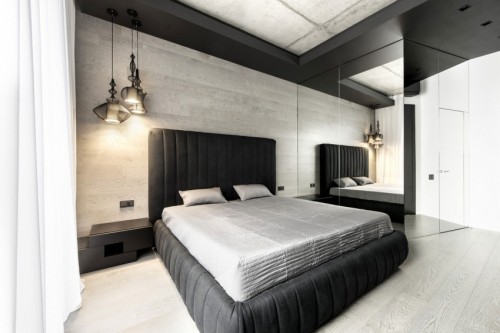 Moderne slaapkamer met een betonnen plafond